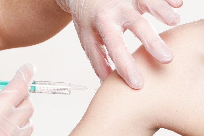 Canva – Hands Applying Vaccine